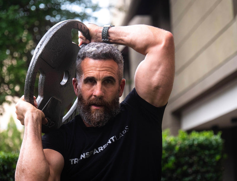 how to get bigger biceps: Man lifting weights at gym