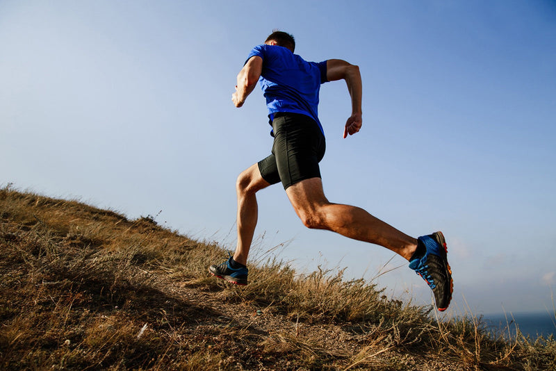 how to run faster: man running up the hill