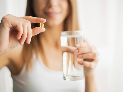 Best supplements for women: Woman drinking pill