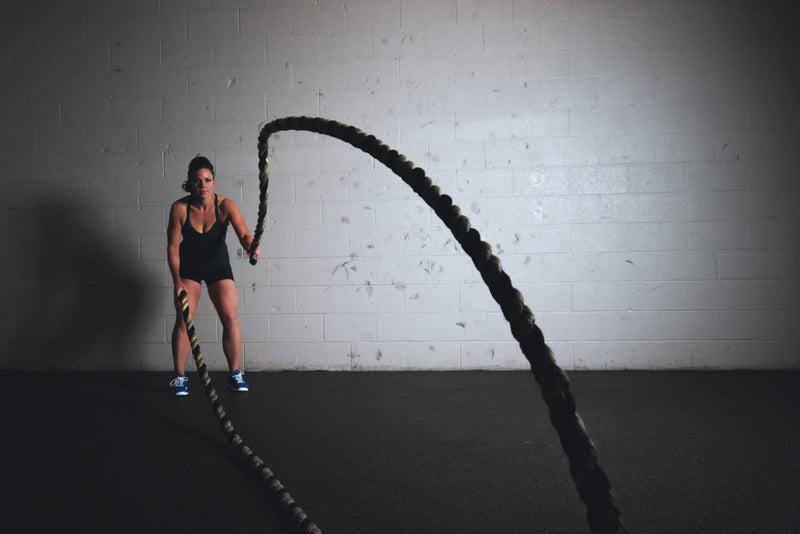 female athlete training with ropes