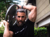 how to get bigger biceps: Man lifting weights at gym