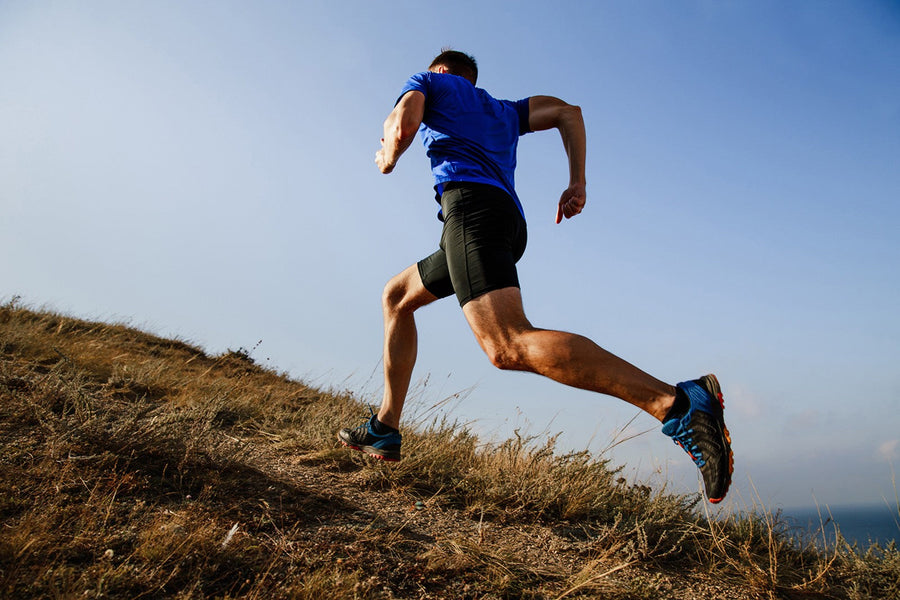 how to run faster: man running up the hill