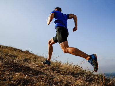 how to run faster: man running up the hill