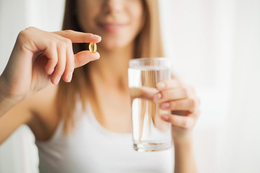 Best supplements for women: Woman drinking pill