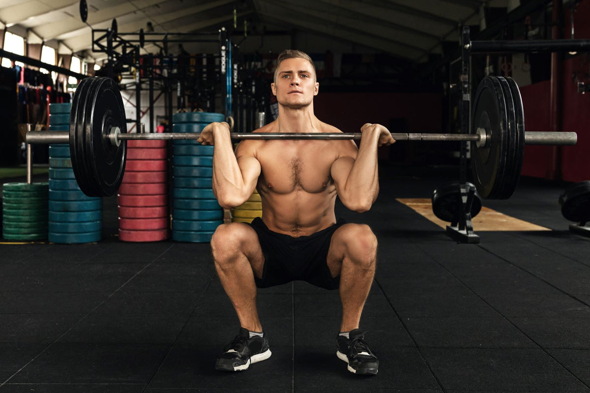 Man doing quad exercises in a gym