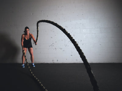 female athlete training with ropes